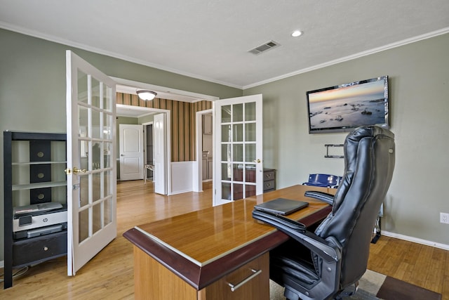 office space featuring french doors, light wood-type flooring, and crown molding