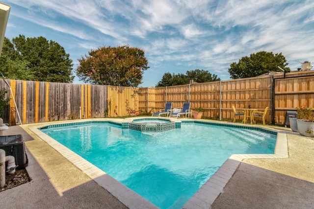 view of swimming pool featuring an in ground hot tub and a patio