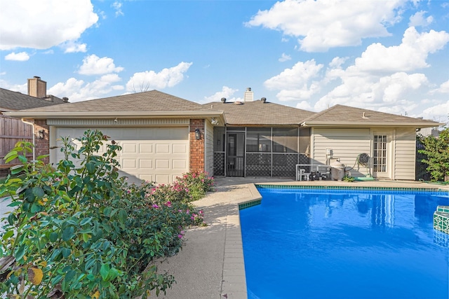 view of pool with a sunroom