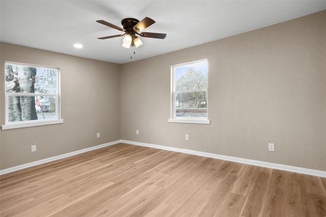 empty room with ceiling fan and light wood-type flooring