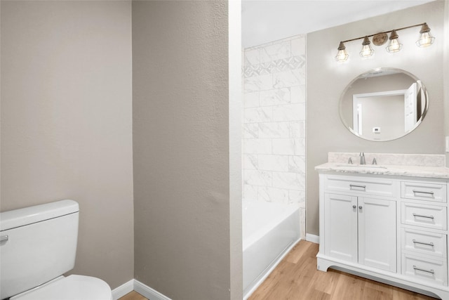 full bathroom with vanity, hardwood / wood-style flooring, toilet, and tub / shower combination