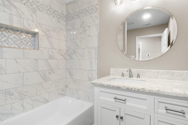 bathroom featuring vanity and tiled shower / bath combo