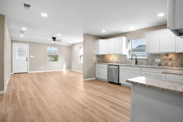 kitchen with white cabinetry, dishwasher, ceiling fan, and light stone counters