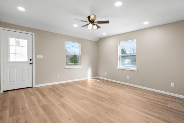 foyer with ceiling fan and light hardwood / wood-style flooring