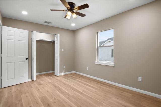 unfurnished bedroom featuring ceiling fan, a closet, and light hardwood / wood-style flooring