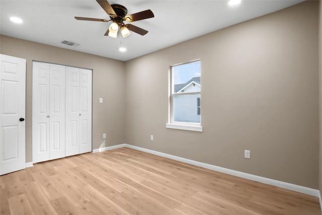 unfurnished bedroom with a closet, ceiling fan, and light hardwood / wood-style flooring