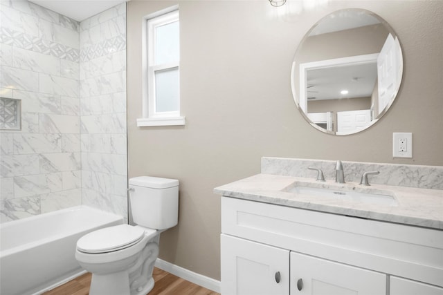 full bathroom featuring toilet, vanity, tiled shower / bath combo, and hardwood / wood-style flooring