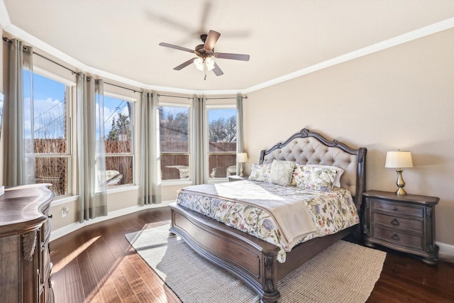 bedroom with ceiling fan, dark hardwood / wood-style floors, and crown molding