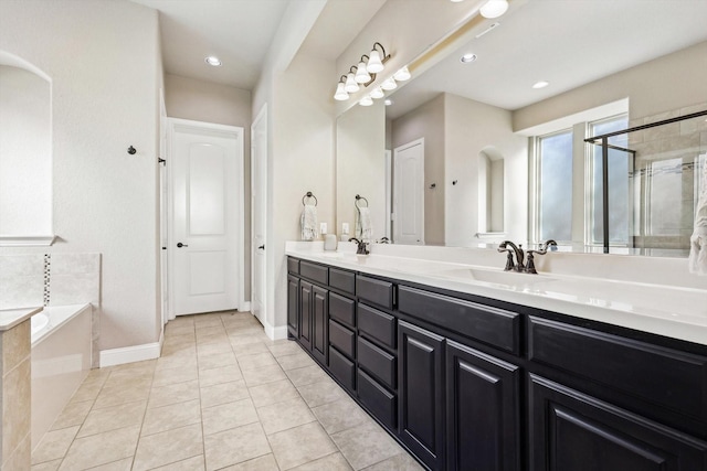 bathroom with shower with separate bathtub, vanity, and tile patterned floors