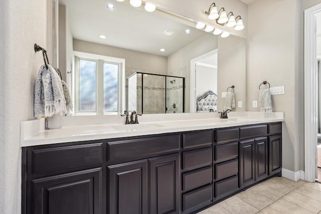 bathroom featuring tile patterned flooring, vanity, and walk in shower