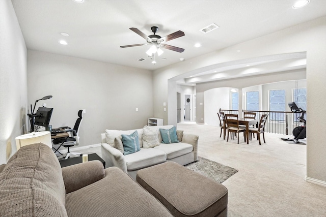 living room featuring light carpet and ceiling fan