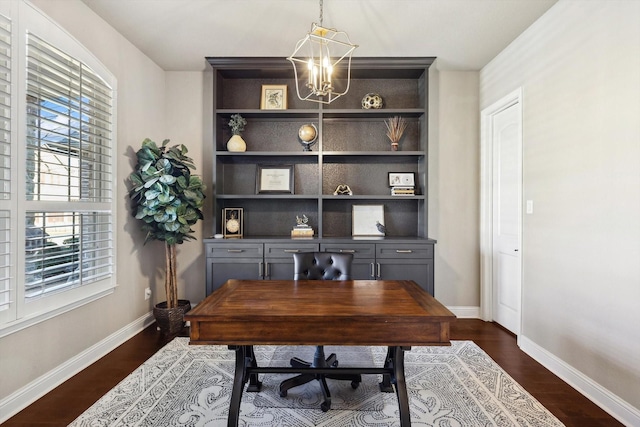 office area with built in features, dark hardwood / wood-style flooring, and an inviting chandelier