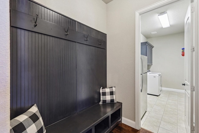 mudroom featuring tile patterned floors and washer and clothes dryer