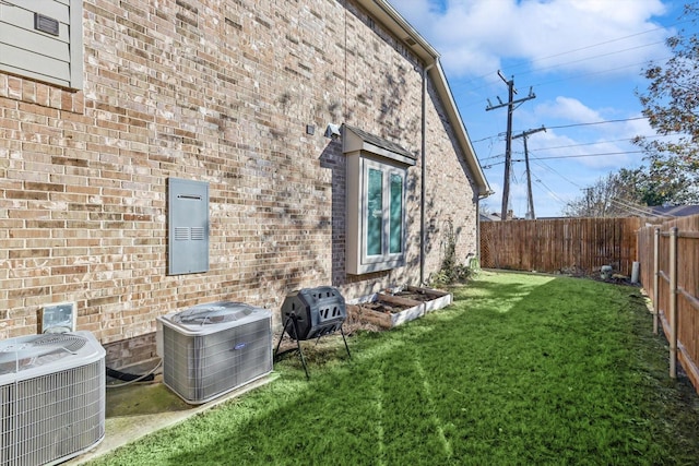 view of side of home with a yard and cooling unit