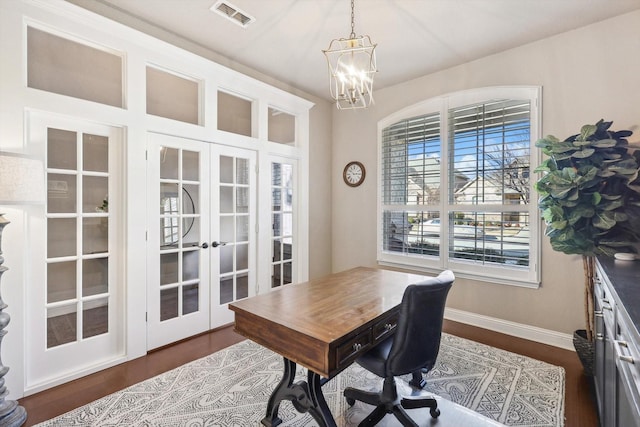 office featuring dark hardwood / wood-style floors, an inviting chandelier, and french doors