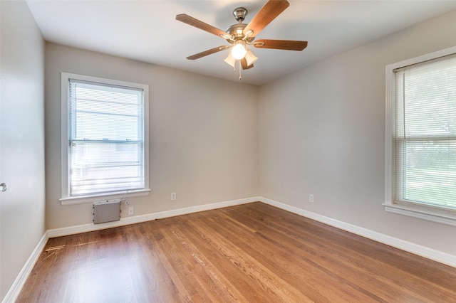 spare room with hardwood / wood-style flooring, plenty of natural light, and ceiling fan