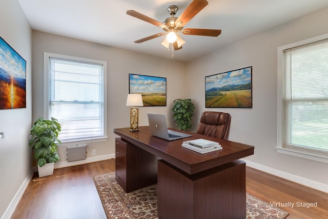 office area with ceiling fan, a healthy amount of sunlight, and dark hardwood / wood-style floors