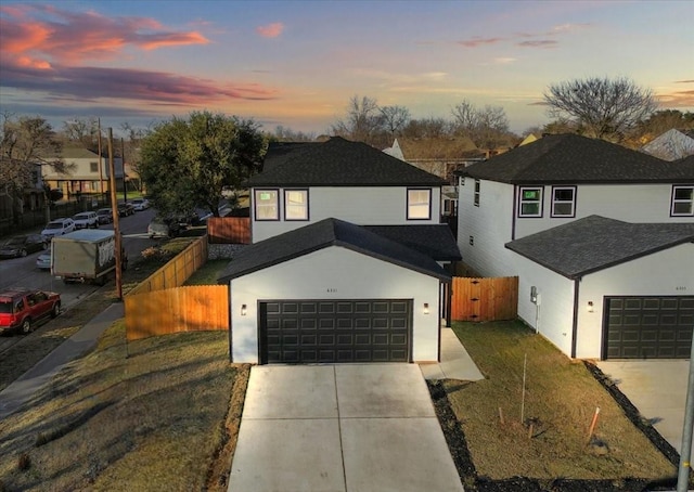 view of front of home featuring a garage and a yard