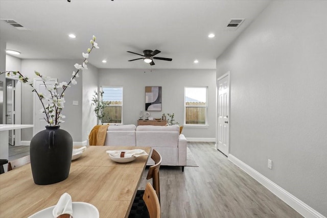 living room featuring ceiling fan, plenty of natural light, and hardwood / wood-style floors