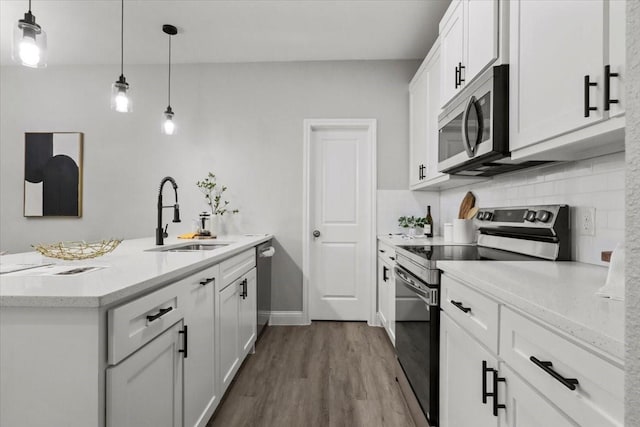 kitchen featuring pendant lighting, sink, white cabinetry, and stainless steel appliances