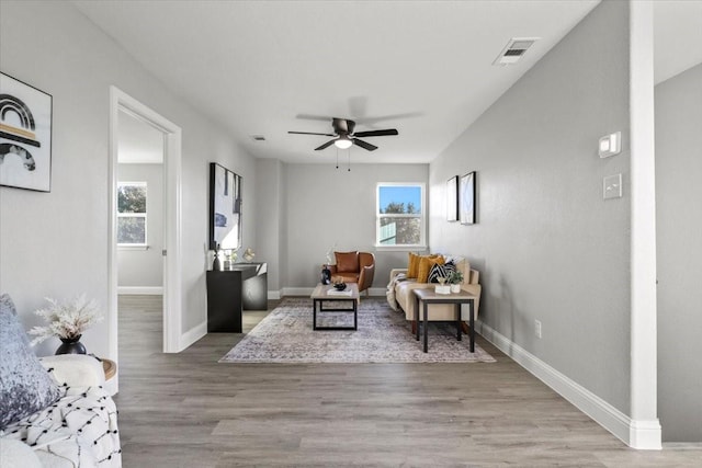 sitting room with light wood-type flooring and ceiling fan