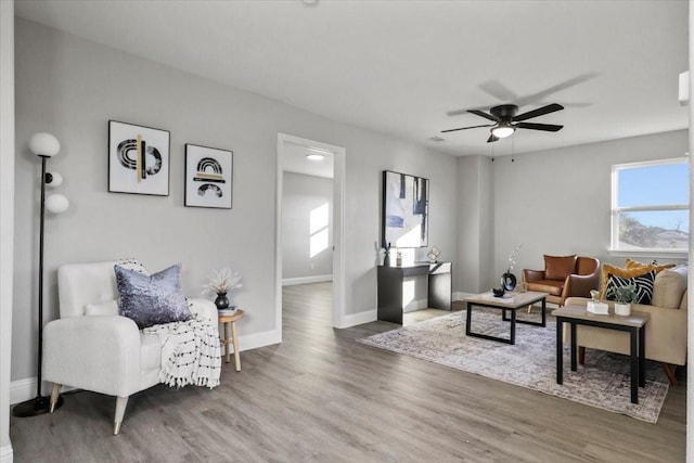 living room featuring ceiling fan and wood-type flooring