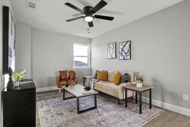 living room with hardwood / wood-style flooring and ceiling fan