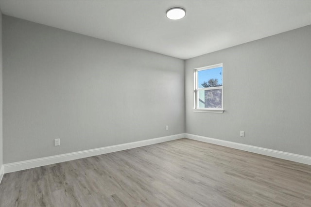 unfurnished room with light wood-type flooring