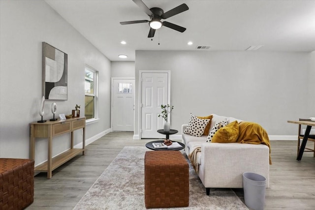 living room with hardwood / wood-style floors and ceiling fan