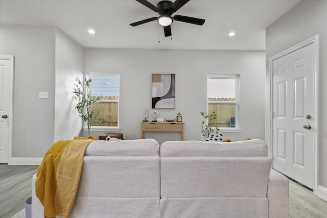 living room with ceiling fan and light hardwood / wood-style floors