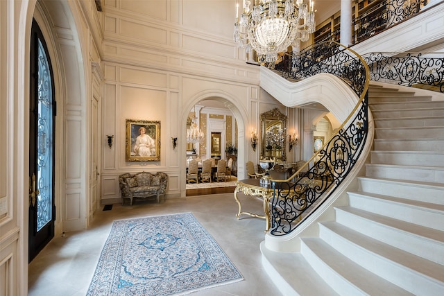 entrance foyer featuring a high ceiling and a notable chandelier