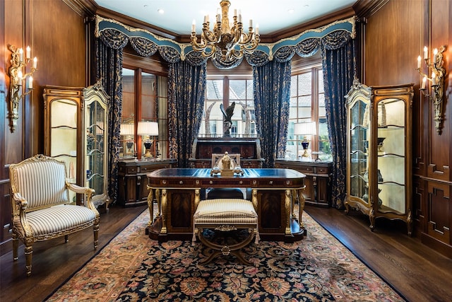 office area with wooden walls, dark hardwood / wood-style floors, crown molding, and a notable chandelier