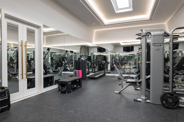 gym with a tray ceiling