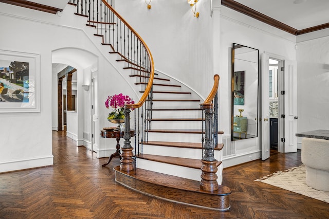 stairs featuring parquet flooring and ornamental molding