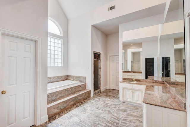 bathroom with vanity and independent shower and bath