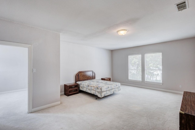 bedroom featuring light carpet