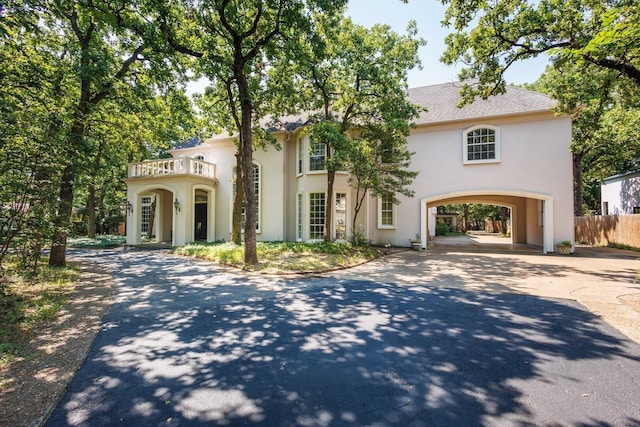 view of front of property with a balcony and a carport