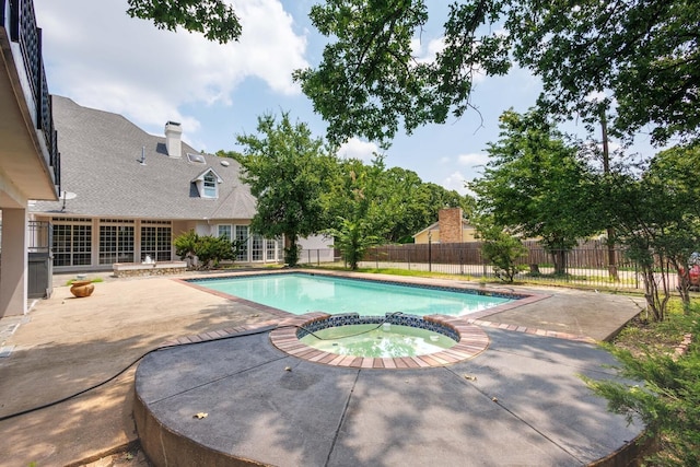 view of swimming pool featuring an in ground hot tub and a patio area