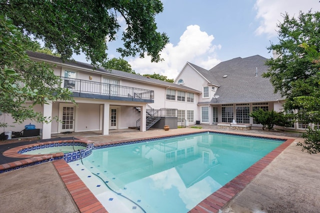 view of pool featuring an in ground hot tub and a patio