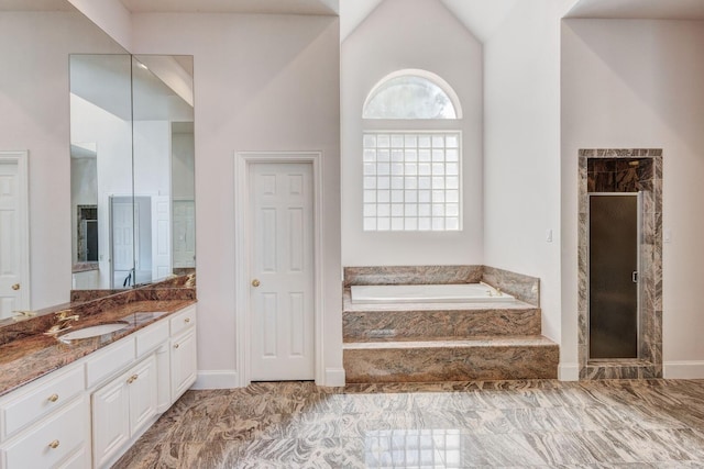 bathroom featuring vanity and independent shower and bath