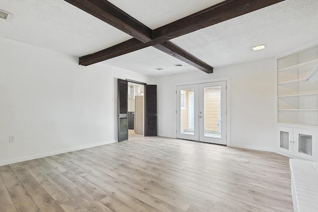 unfurnished living room with french doors, beamed ceiling, a textured ceiling, and light hardwood / wood-style flooring