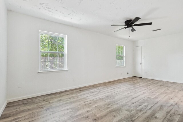 unfurnished room with ceiling fan and light wood-type flooring