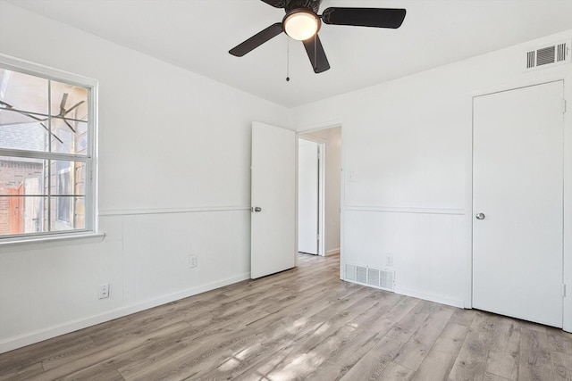 unfurnished bedroom with ceiling fan and light wood-type flooring