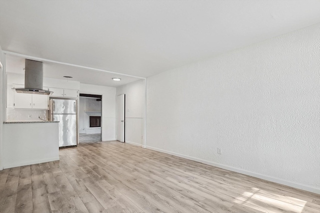 unfurnished living room with light hardwood / wood-style flooring