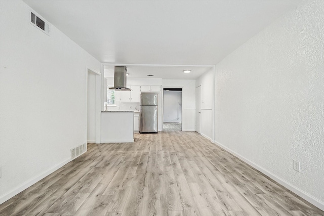 unfurnished living room with light hardwood / wood-style floors