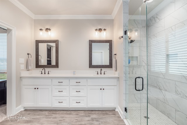 bathroom with wood-type flooring, vanity, walk in shower, and crown molding