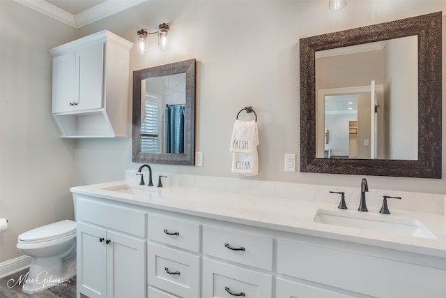 bathroom with vanity, toilet, walk in shower, and ornamental molding