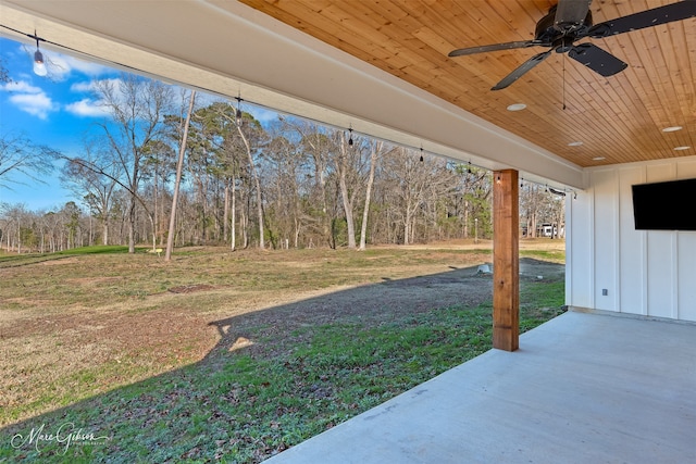 view of yard with ceiling fan and a patio