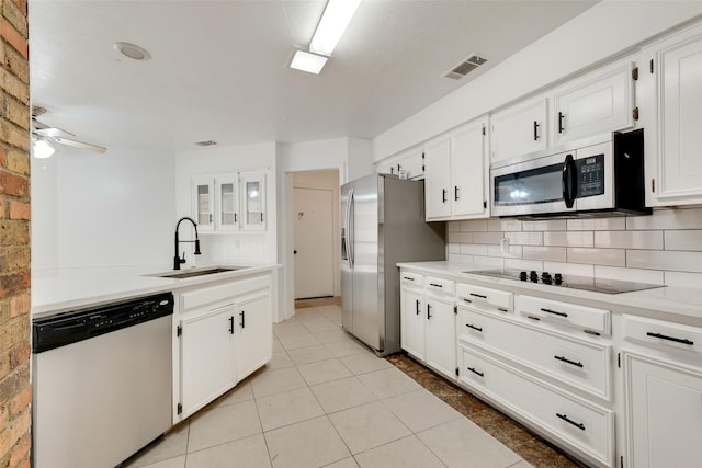 kitchen with sink, stainless steel appliances, and white cabinetry