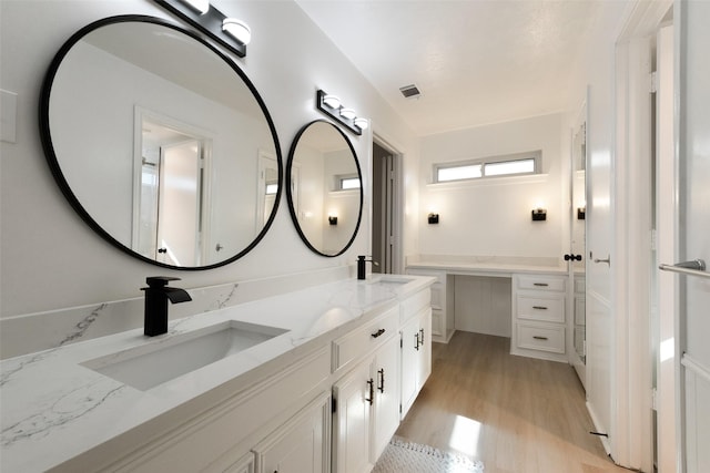 bathroom with vanity and hardwood / wood-style flooring